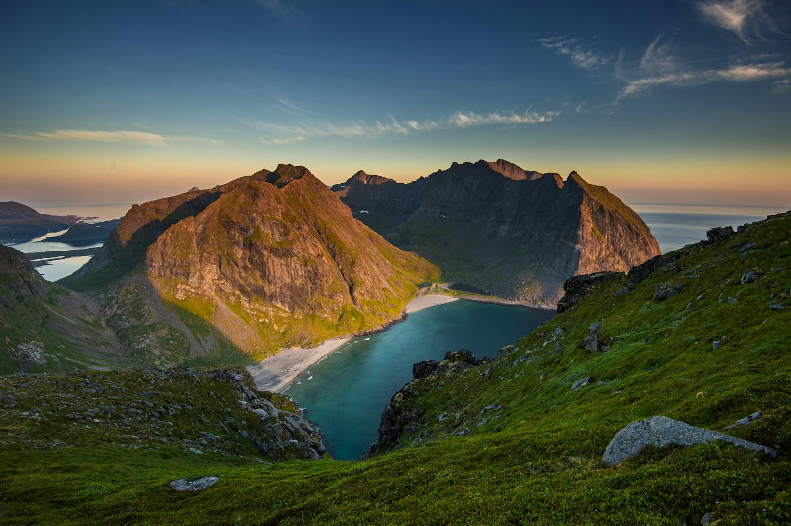 Scenic view of Lofoten Islands landscape at sunset with mountains and fjord.