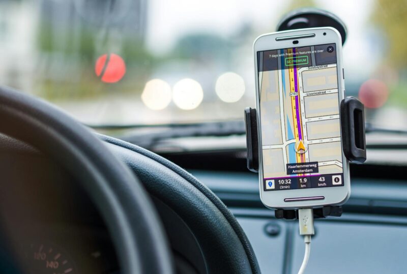 Smartphone mounted in car using GPS for navigation and directions.