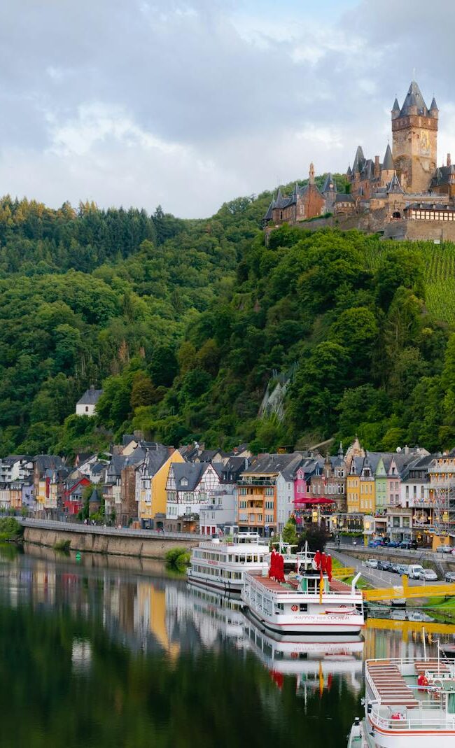 Idyllic landscape of Cochem Castle overlooking Moselle River in Germany.