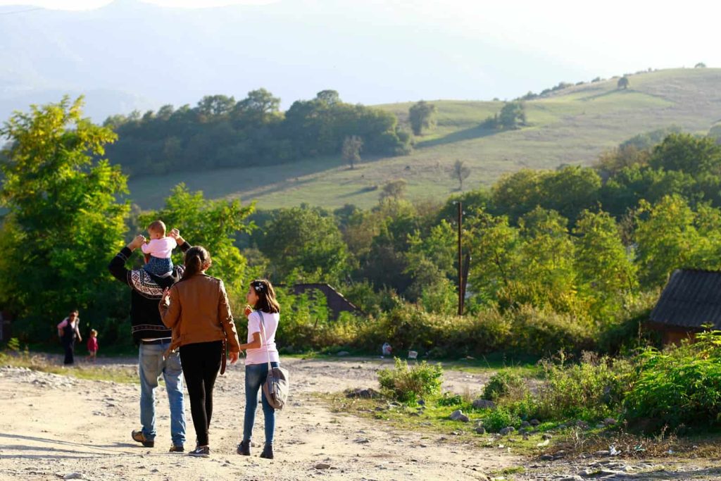 people walking on dirt road during daytime
