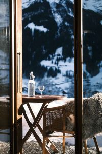 a table with a bottle of wine and a glass of wine on it