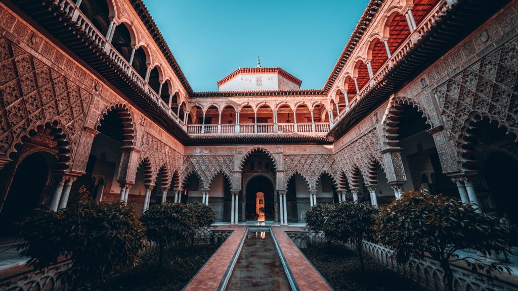 Stunning view of the intricate courtyard architecture at Alcázar of Seville in Spain.