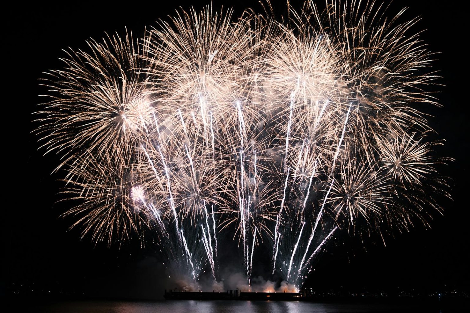 Spectacular fireworks display illuminates the night sky over Vancouver, creating a vibrant celebration scene.
