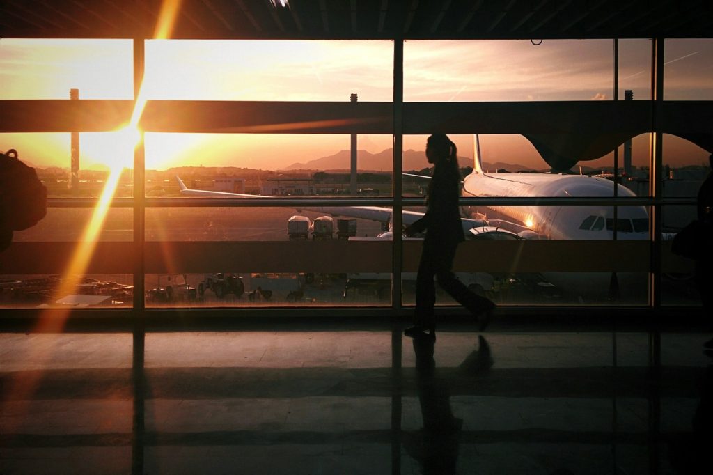 Airport travel hacks-silhouette of person walking beside airplane