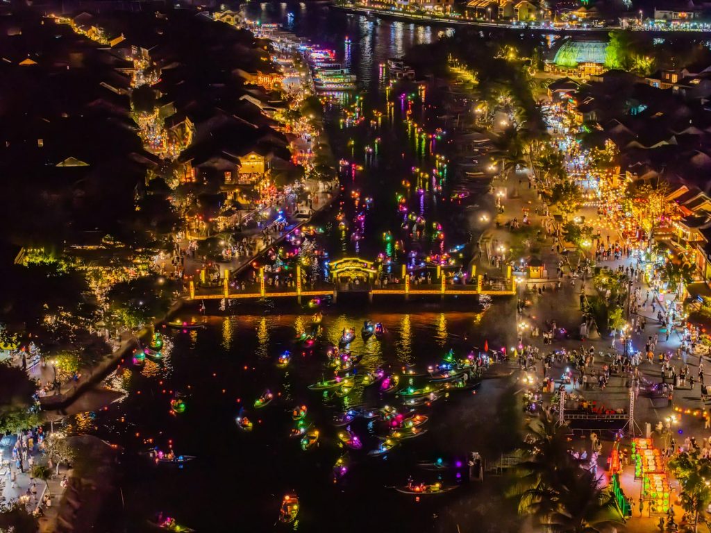 A vibrant aerial shot of Hội An's lantern festival, showcasing colorful lights and bustling waterfront.