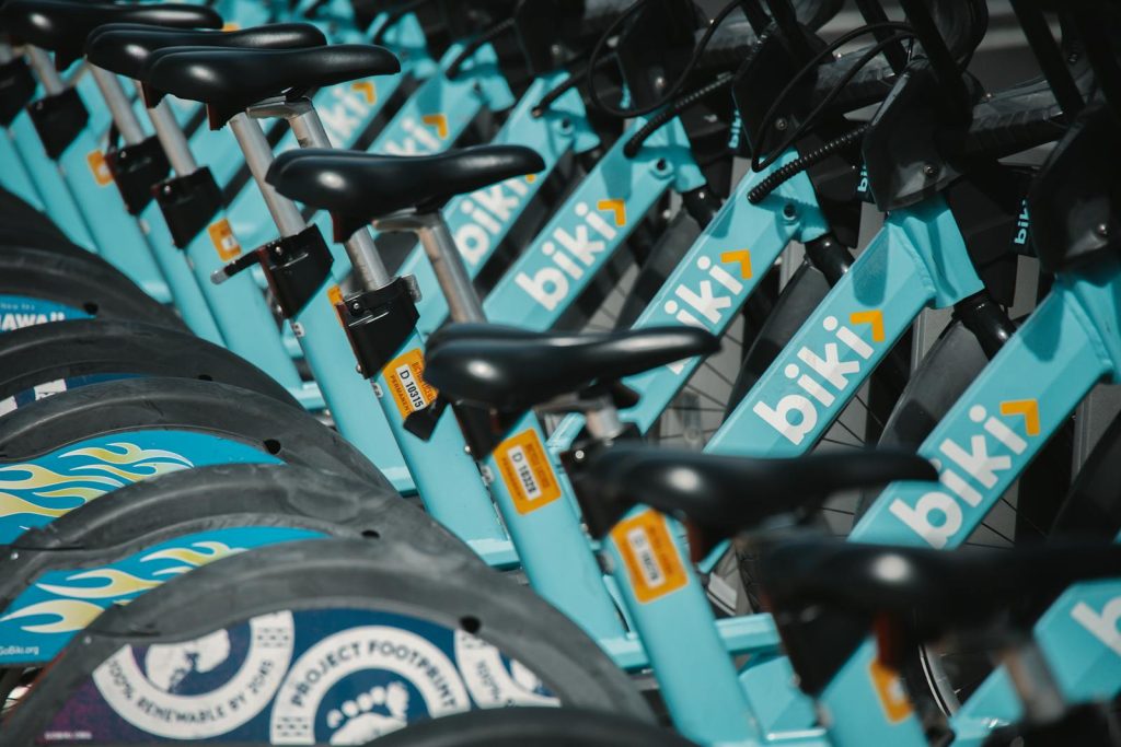 Close-up of a line of blue Biki rental bicycles neatly arranged at a station.