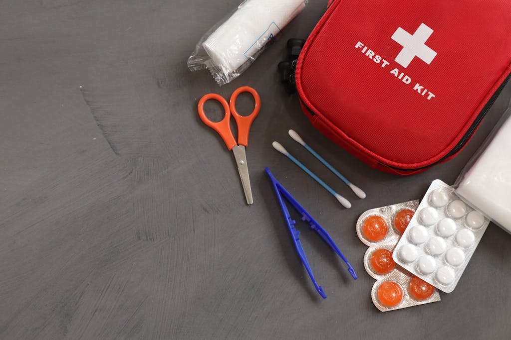 A comprehensive first aid kit with essential medical tools and supplies for emergencies.