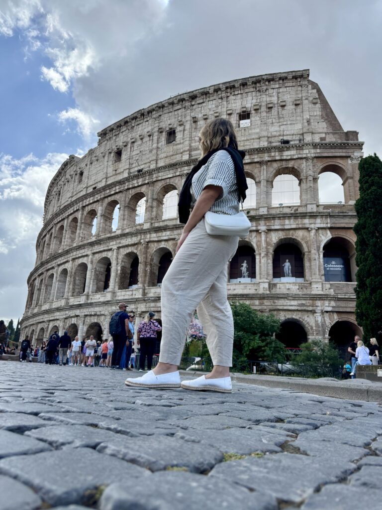Rome travel guide.  Lou in front of the Colosseum