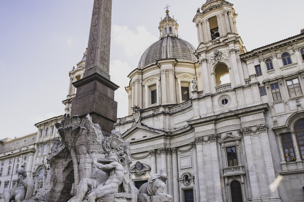 Stunning view of Fontana dei Quattro Fiumi and church facade in Piazza Navona, Rome.