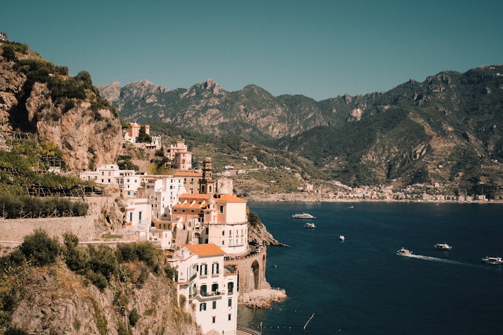 A captivating aerial shot of Atrani on the Amalfi Coast, showcasing historic buildings and azure sea.