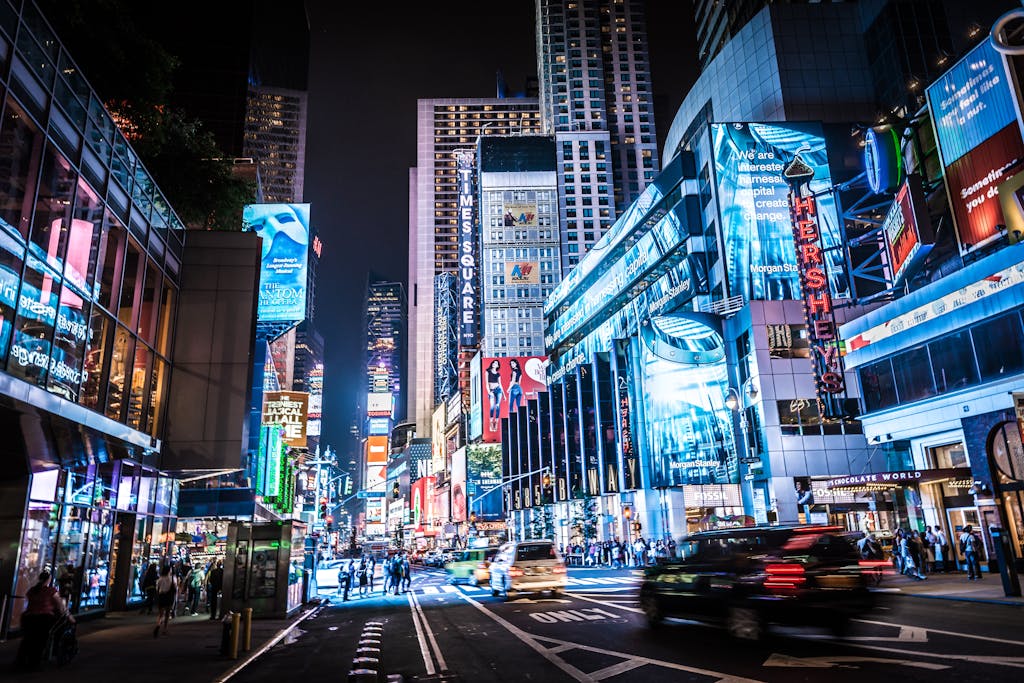 Experience the bustling city life of Times Square, New York City, captured at night in vivid colors and lights.